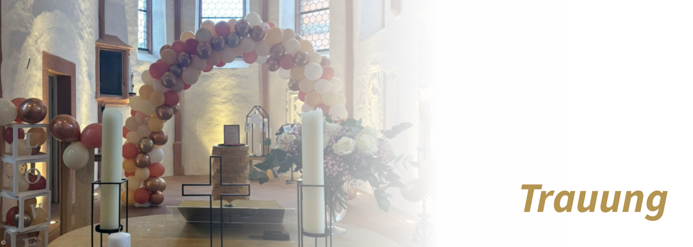 Mit Luftballonbogen in weiß und rosé geschmückte Kirche zu einer Hochzeit